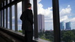 Video: Businessman looks out office windows turns and smiles Businessman looks out office windows turns and smiles
