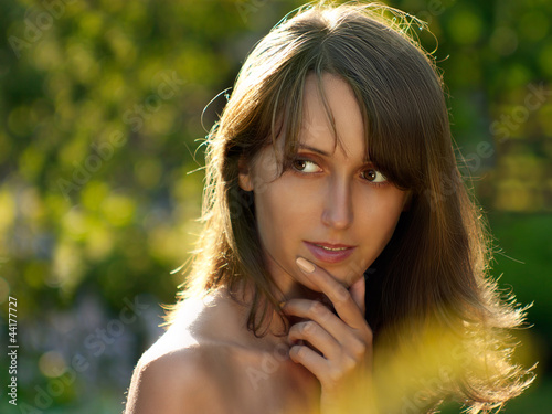 Photo: Portrait of Young Woman on Green Background Portrait of Young Woman on Green Background
