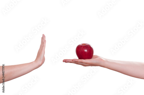 Photo: Hand lehnt einen Apfel ab Hand lehnt einen Apfel ab