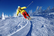 Skier skiing downhill in mountains