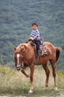 Photo: Boy riding horse in Crimea mountains. Boy riding horse in Crimea mountains.