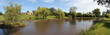 Panoramic view of a house with a pond