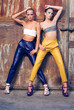 Two fashion girls against rusty doors