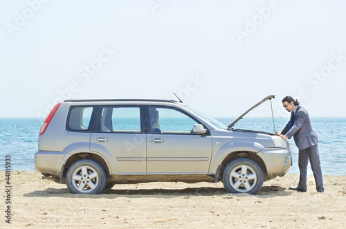 Photo: Man with car on seaside Man with car on seaside
