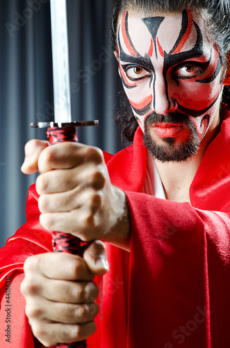 Photo: Man with face mask and sword Man with face mask and sword