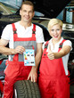 Apprentice and mechanic showing thumb up for tyre labeling
