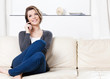 Sitting on the sofa pretty woman speaks on the phone