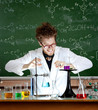 Laughing mad professor combines some liquids in his laboratory