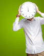 Photo: Young Man Holding Big Clock Covering His Face Young Man Holding Big Clock Covering His Face