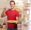 portrait of a young man eating pizza