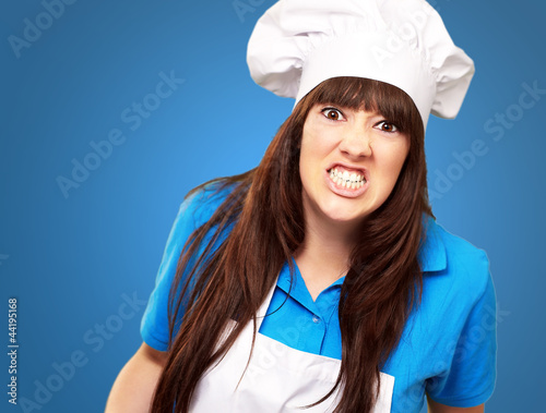 Photo: portrait of a female chef clenching portrait of a female chef clenching