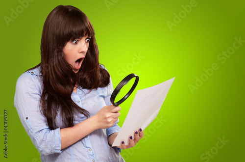 Photo: Portrait Of A Girl Holding A Magnifying Glass And Paper Portrait Of A Girl Holding A Magnifying Glass And Paper