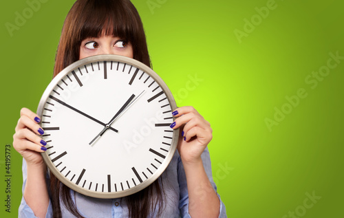 Photo: A Young Girl Holding A Clock A Young Girl Holding A Clock