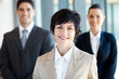 elegant middle aged businesswoman leader and team