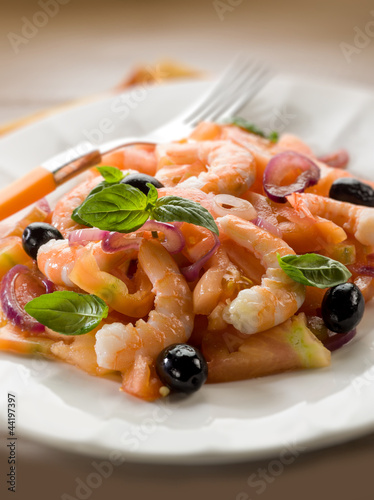 Photo: salad with shrimp tomatoes and black olives, selective focus salad with shrimp tomatoes and black olives, selective focus