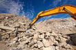 Photo: Demolition waste recycling site and excavator boom Demolition waste recycling site and excavator boom