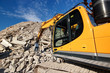 Excavator in demolition waste recycling site Excavator in demolition waste recycling site