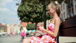 Happy young woman using smartphone in the city