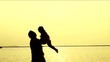Silhouette of Father and Daughter at Beach