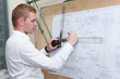Photo: Engineer making blueprint project on old-fashioned drawing board Engineer making blueprint project on old-fashioned drawing board