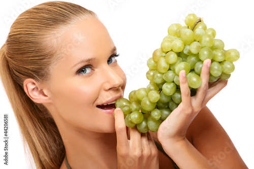 Photo: closeup portrait of a healthy woman bites in grape closeup portrait of a healthy woman bites in grape