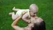 Video: happy mother with baby playing on green grass happy mother with baby playing on green grass