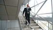 Video: senior business man walking down the stairs and talking on phone senior business man walking down the stairs and talking on phone