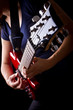 Closeup view of playing electric red guitar