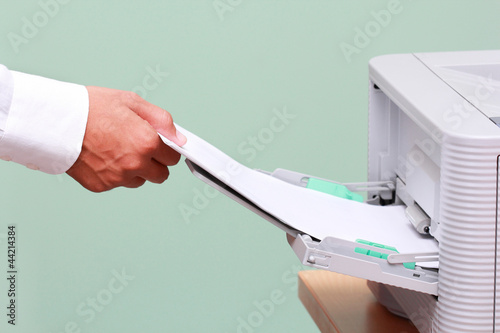 Photo: Businessman working with printer Businessman working with printer