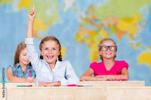 Photo: Back to school - elementary school pupil raising hand Back to school - elementary school pupil raising hand