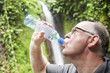 Adult man drinking a cold bottle of water