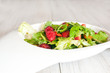 Fresh green salad with raspberries and strawberries