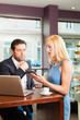 Working colleagues - man and woman - sitting in cafe