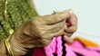 female elder knitting hand close up