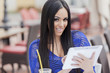 Girl with tablet in restaurant