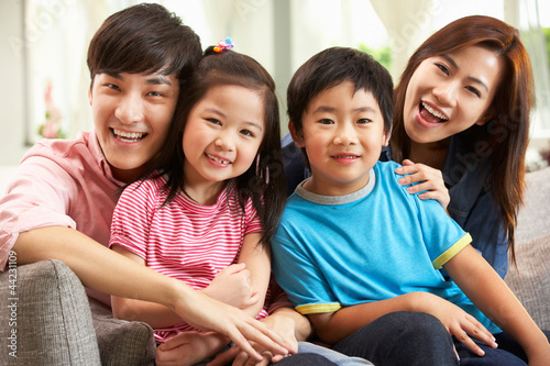 Photo: Chinese Family Relaxing On Sofa At Home Chinese Family Relaxing On Sofa At Home