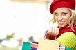 Autumn woman carrying shopping bags walking city street