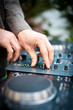 Photo: Young man working as dj with mixer. Shallow focus on hands. Young man working as dj with mixer. Shallow focus on hands.