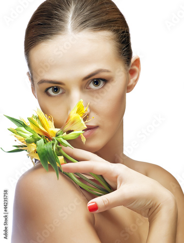 Photo: portrait of brunette spa woman with flower portrait of brunette spa woman with flower