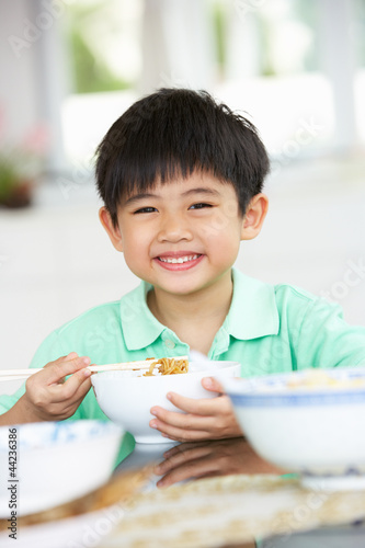 Photo: Young Chinese Boy Sitting At Home Eating Meal Young Chinese Boy Sitting At Home Eating Meal