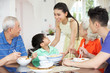 Portrait Of Multi-Generation Chinese Family Eating Meal Together