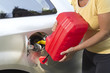 Adding fuel in car with plastic can