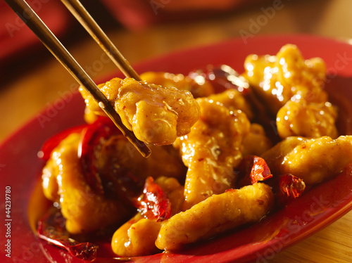 Photo: Chinese food - Eating general tso's chicken with chopsticks. Chinese food - Eating general tso's chicken with chopsticks.