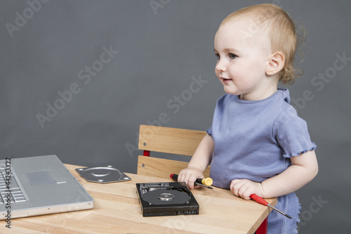 Photo: child working at open hard drive child working at open hard drive
