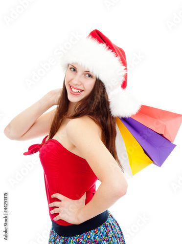 Photo: pretty girl in christmass hat with colorful bags pretty girl in christmass hat with colorful bags
