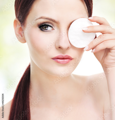Photo: Make up removal, beautiful young adult woman with cotton pad Make up removal, beautiful young adult woman with cotton pad