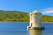 Foto: Old windmill in harbor of orbetello Old windmill in harbor of orbetello