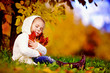 Photo: autumn happy little girl has fun playing with fallen golden leav autumn happy little girl has fun playing with fallen golden leav