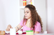 .Young woman eating yogurt