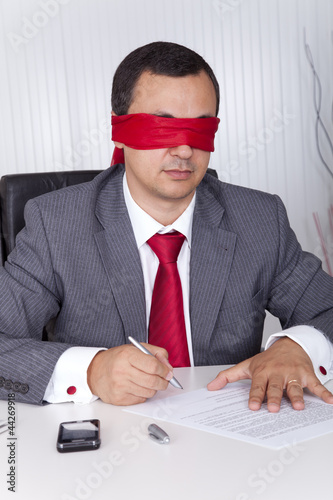 Photo: Blindfold businessman working Blindfold businessman working